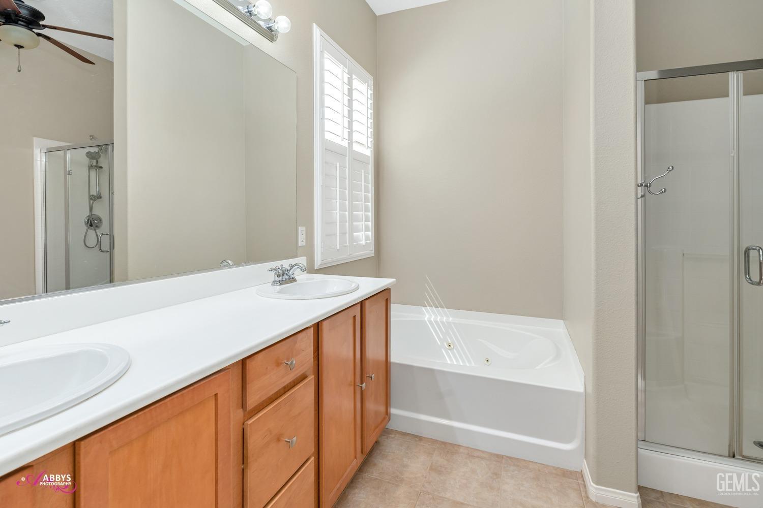 Undisclosed Address Bakersfield, CA 93306 - Photo 17 of 49 a bathroom with a tub sink and mirror