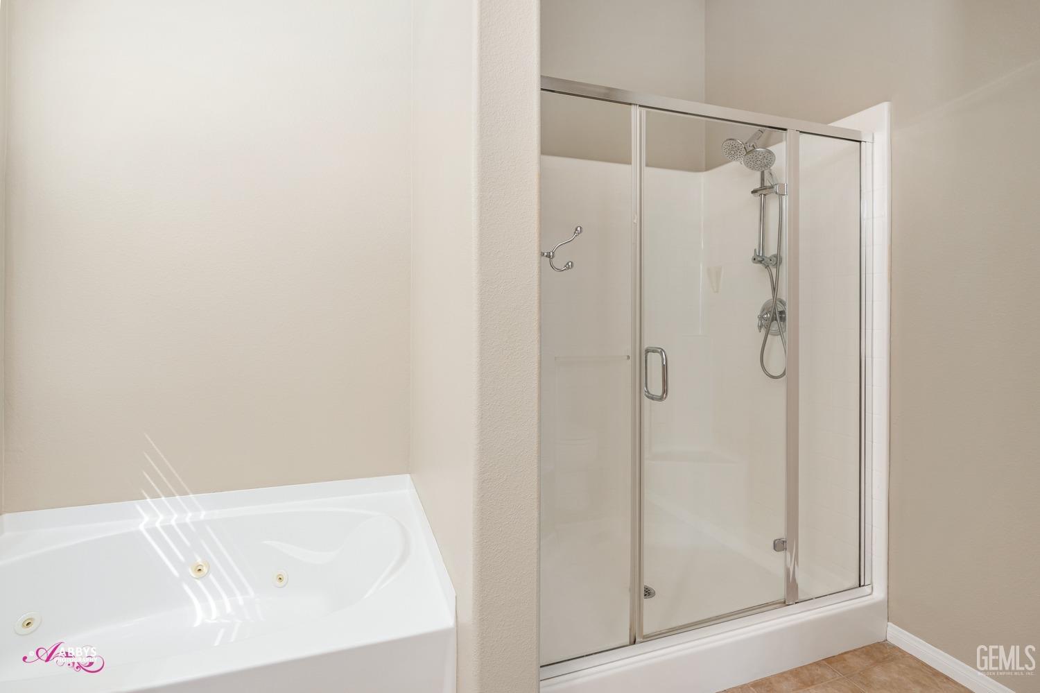 Undisclosed Address Bakersfield, CA 93306 - Photo 18 of 49 a bathroom with a shower and a sink