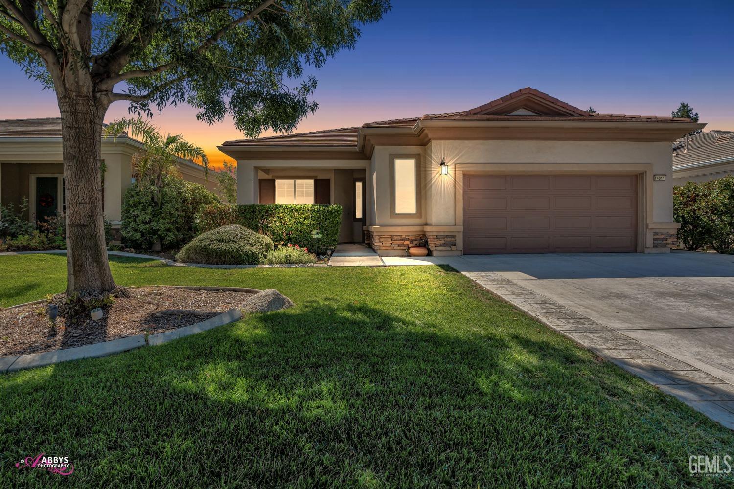 Undisclosed Address Bakersfield, CA 93306 - Photo 2 of 49 a front view of a house with a yard