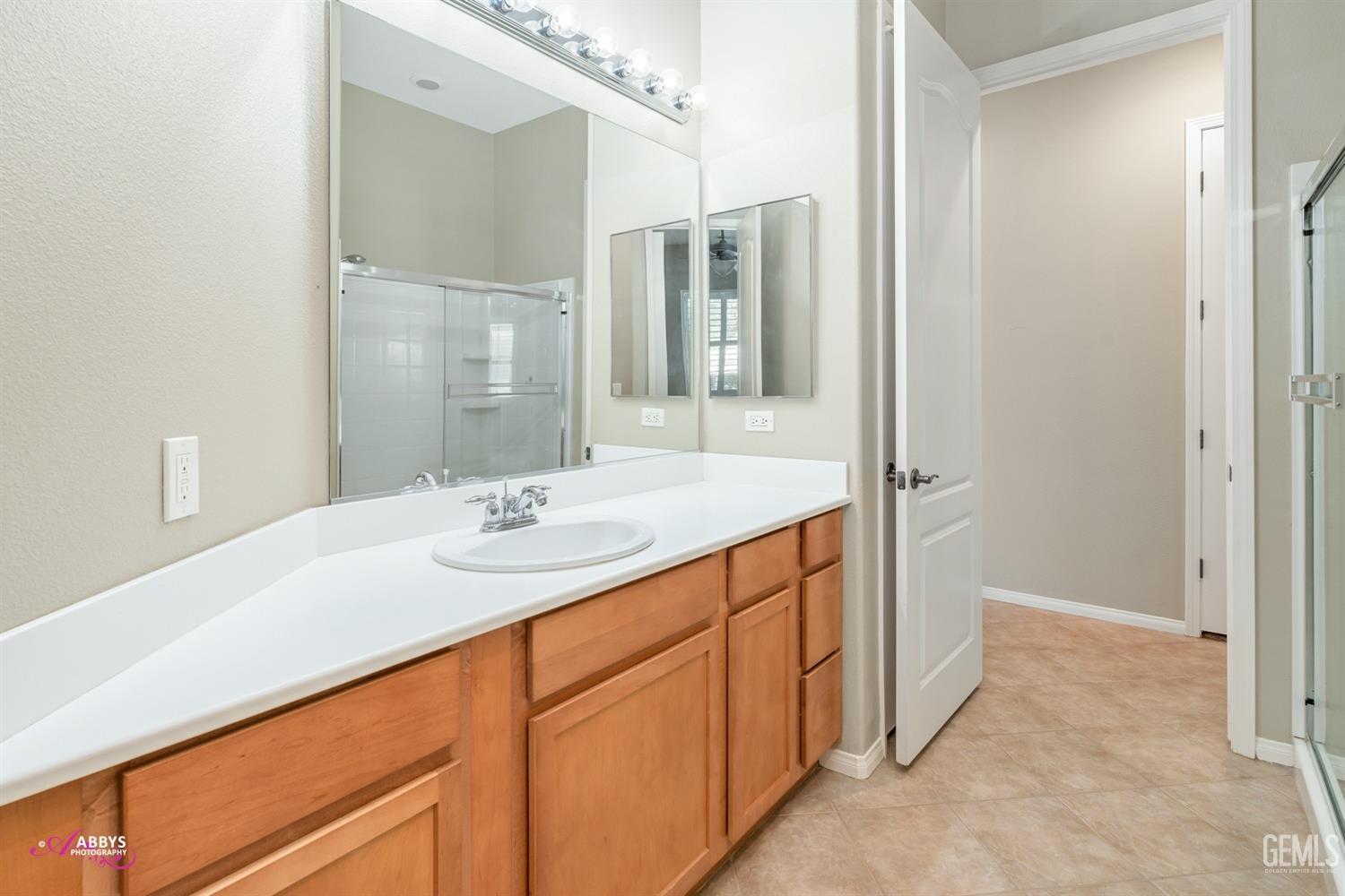Undisclosed Address Bakersfield, CA 93306 - Photo 21 of 49 a bathroom with a sink and a mirror