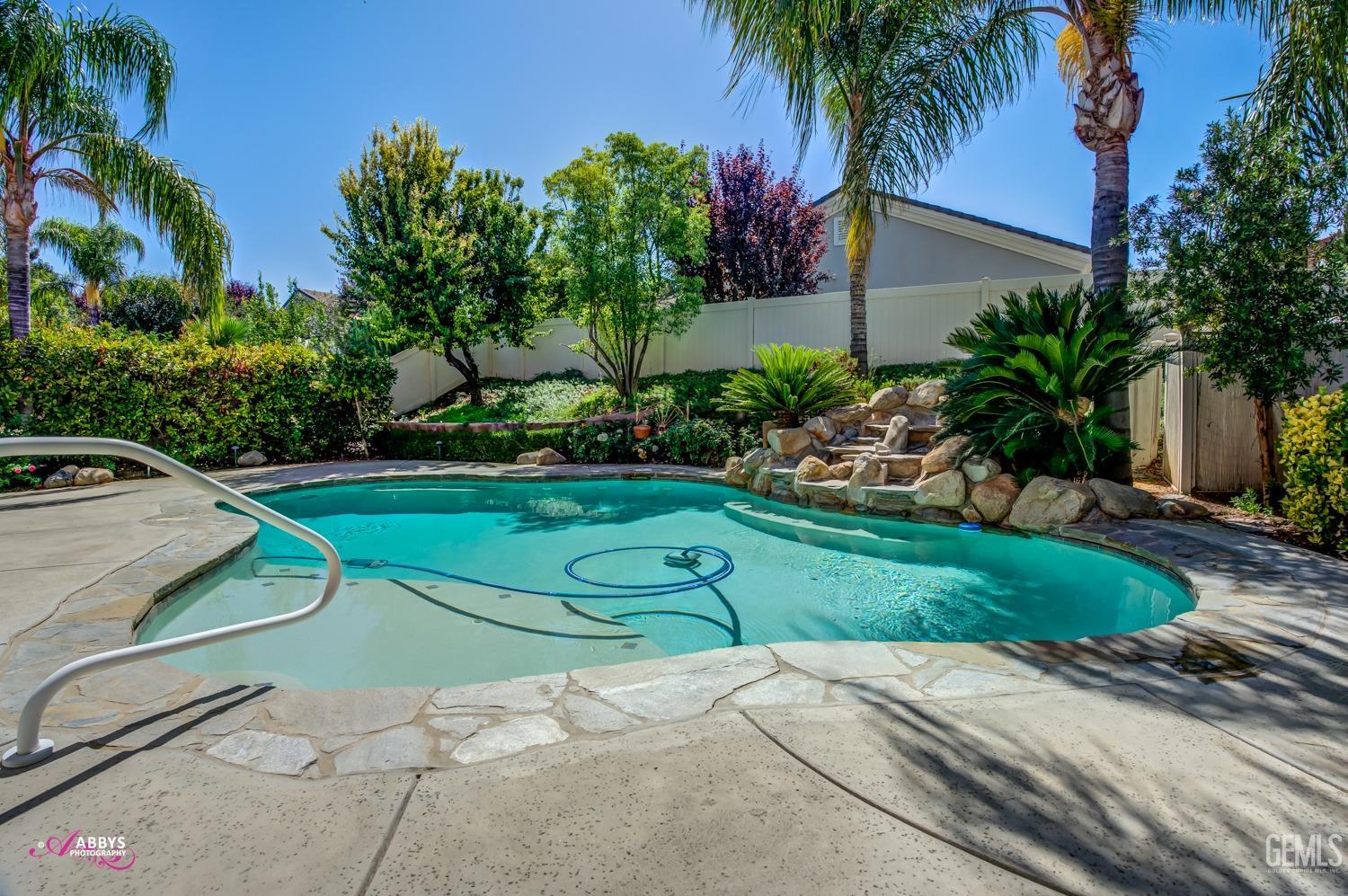 Undisclosed Address Bakersfield, CA 93306 - Photo 23 of 49 a view of a table and chairs in a backyard