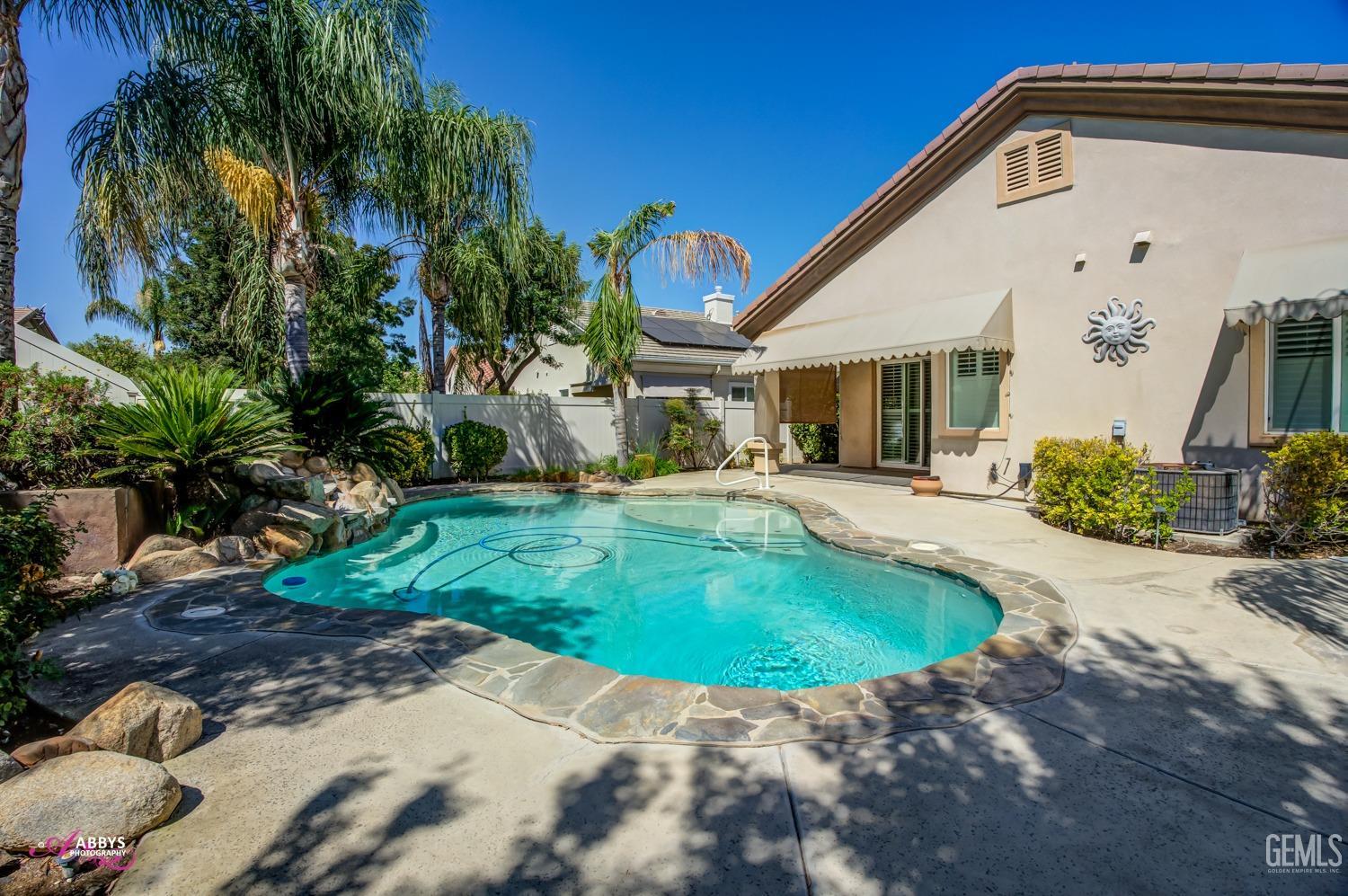 Undisclosed Address Bakersfield, CA 93306 - Photo 27 of 49 a swimming pool with outdoor seating and yard