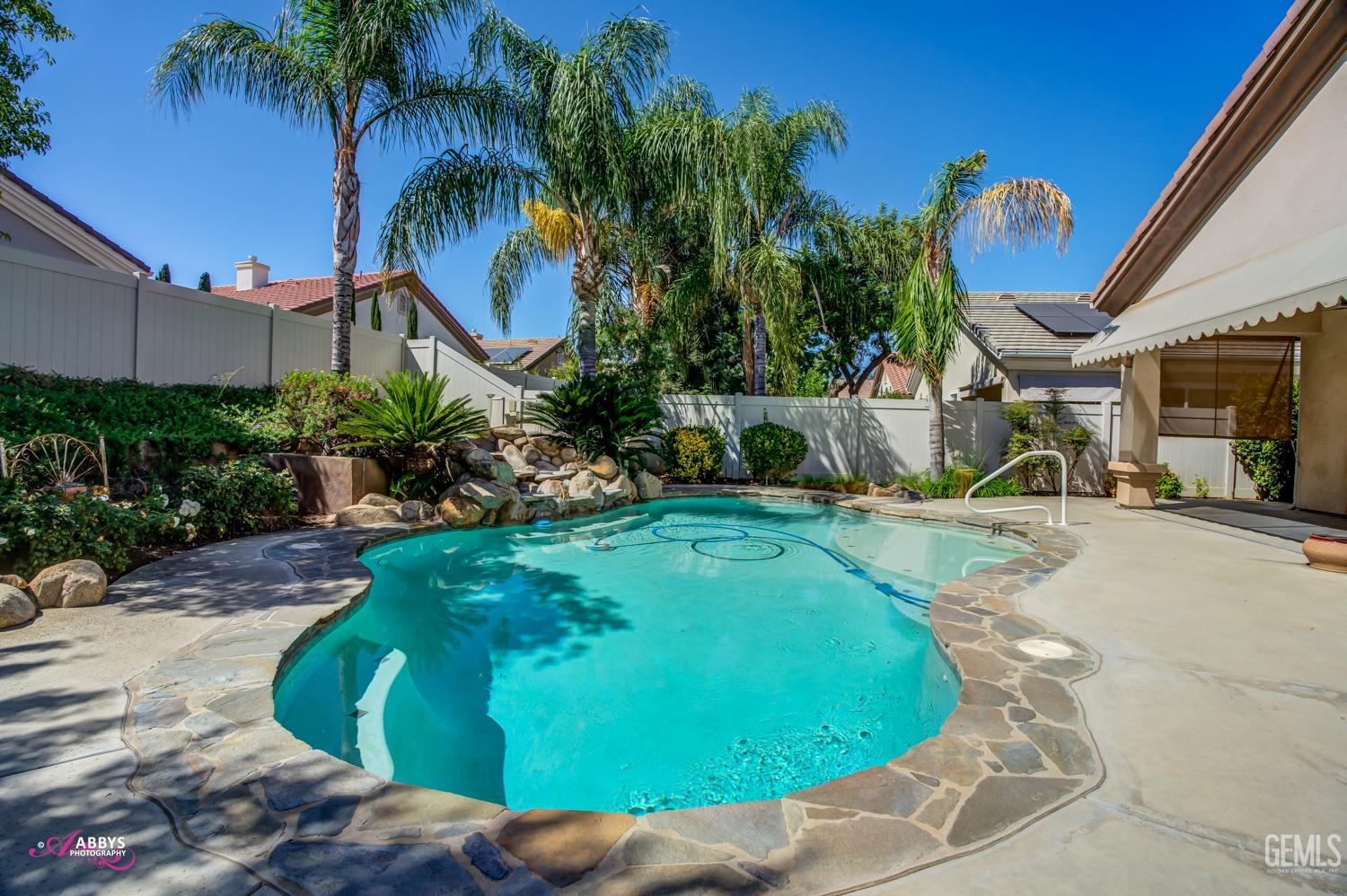 Undisclosed Address Bakersfield, CA 93306 - Photo 28 of 49 a swimming pool with outdoor seating and plants