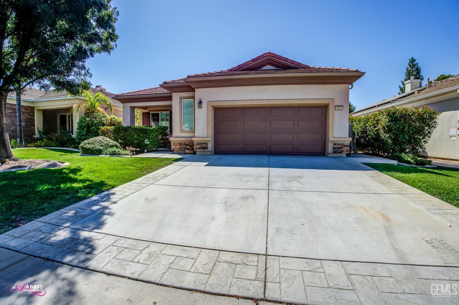 Undisclosed Address Bakersfield, CA 93306 - Photo 3 of 49 a front view of a house with a yard