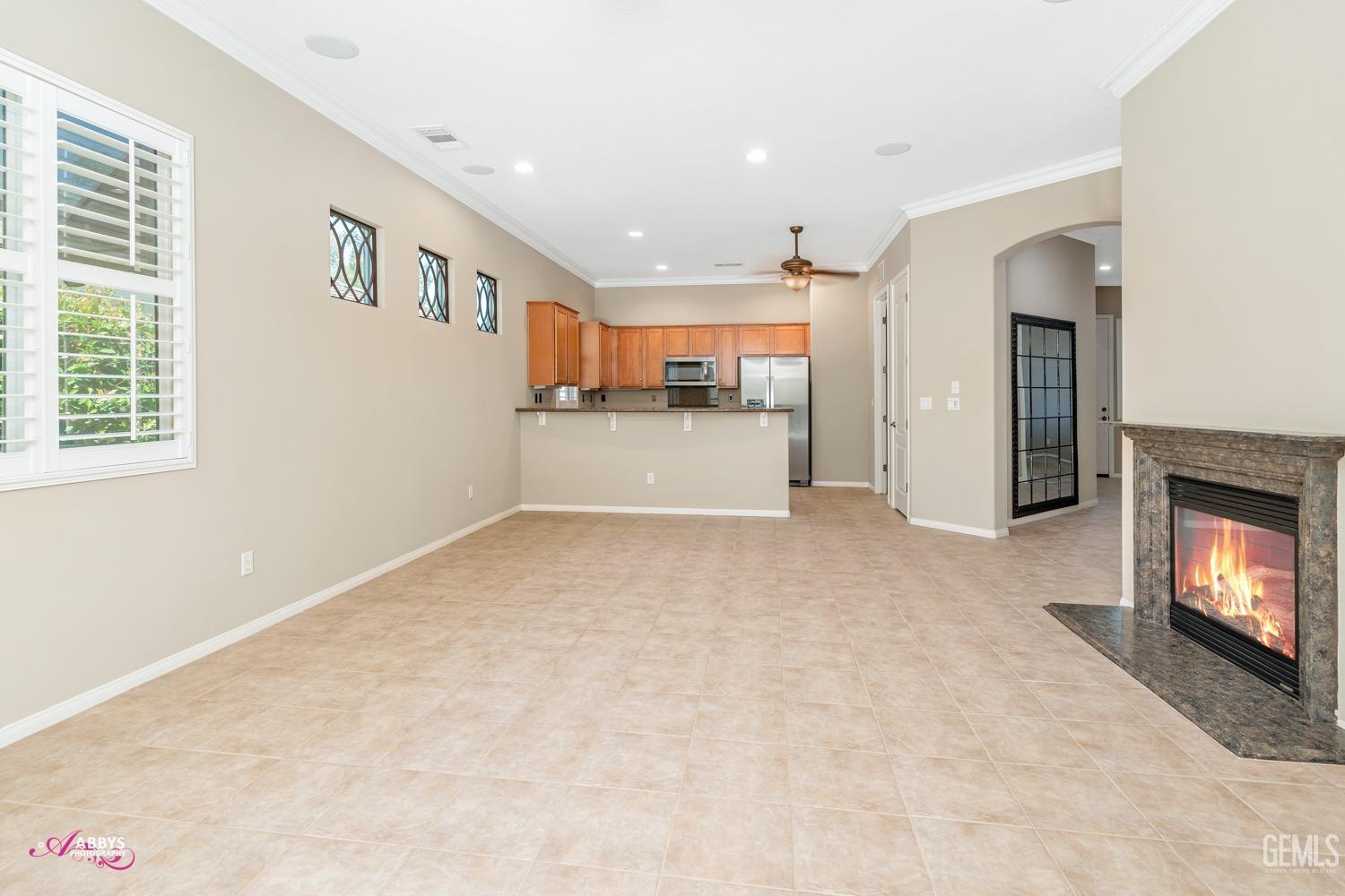 Undisclosed Address Bakersfield, CA 93306 - Photo 9 of 49 a view of an empty room with a fireplace