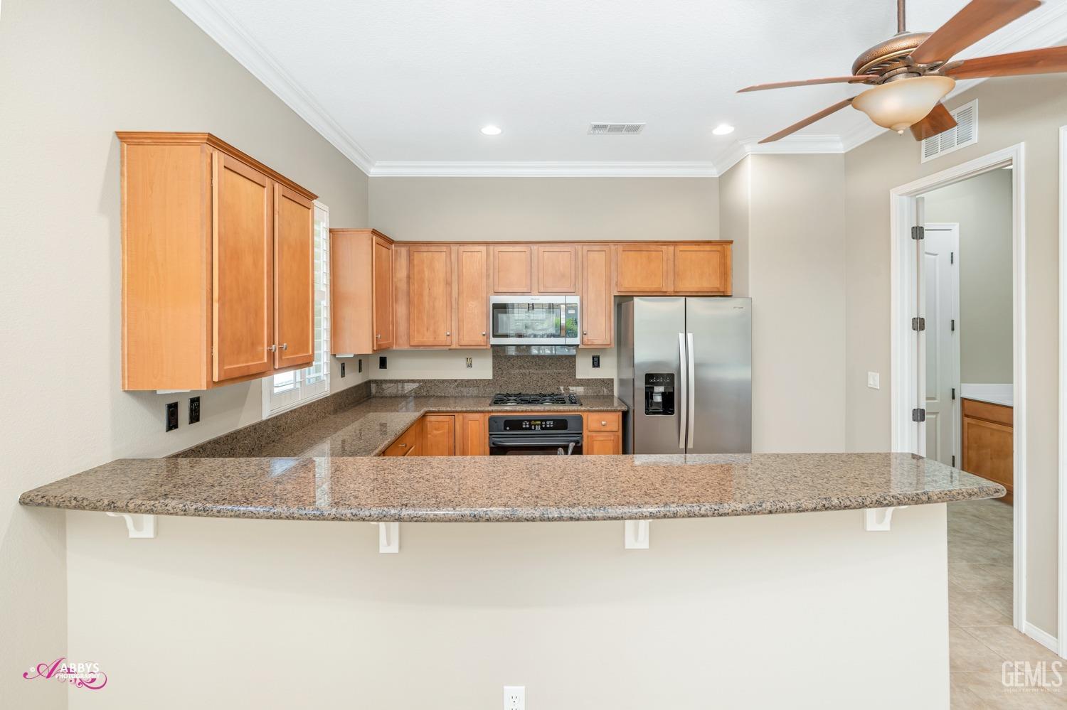 Undisclosed Address Bakersfield, CA 93306 - Photo 10 of 49 a kitchen with stainless steel appliances granite countertop a sink a stove and a refrigerator