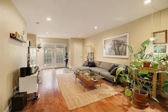 a living room with furniture and a wooden floor