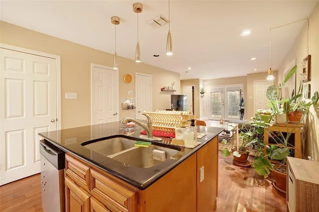 a kitchen with a sink a counter and chairs