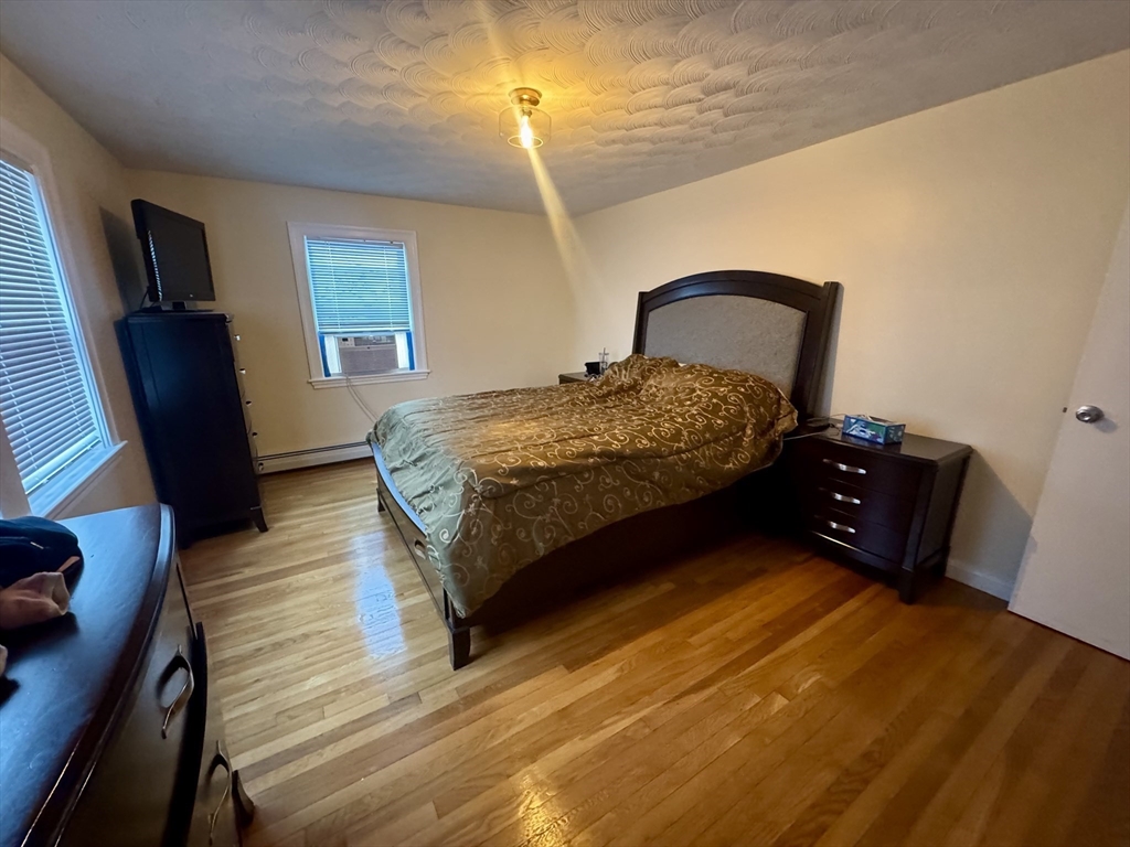 72 Redlands Road Boston, MA 02132 - Photo 16 of 31 a bedroom with a bed dresser and a window