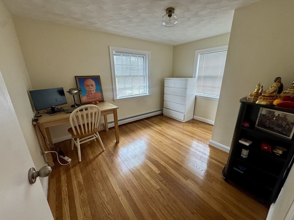 72 Redlands Road Boston, MA 02132 - Photo 22 of 31 a view of a workspace with furniture and a window