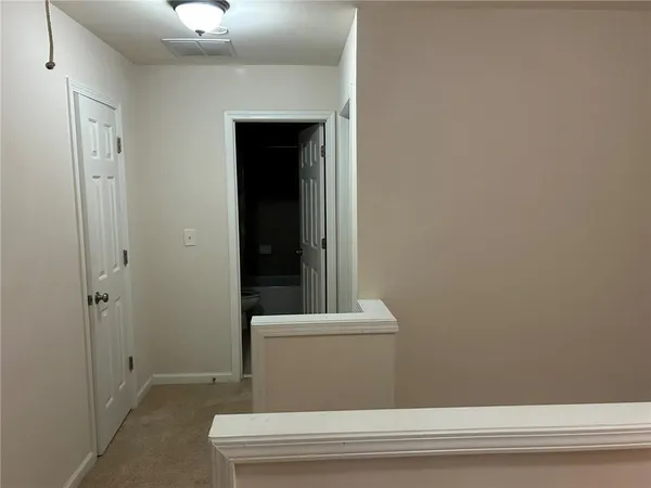 a view of staircase with a fireplace