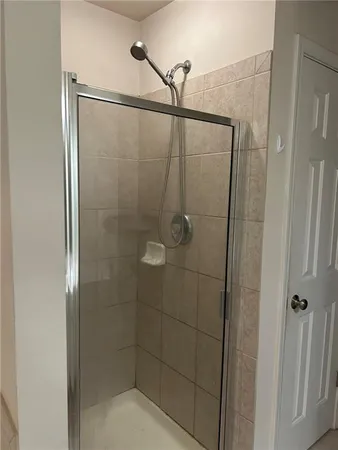 a bathroom with a glass shower door