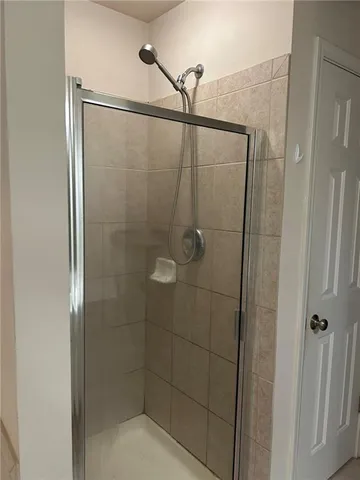 a bathroom with a glass shower door