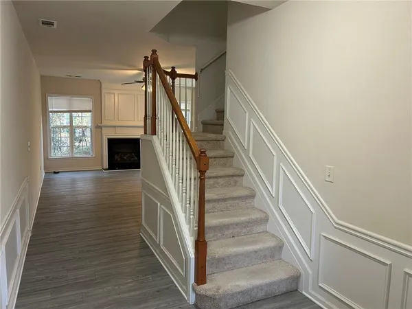 a view of entryway and hall with wooden floor