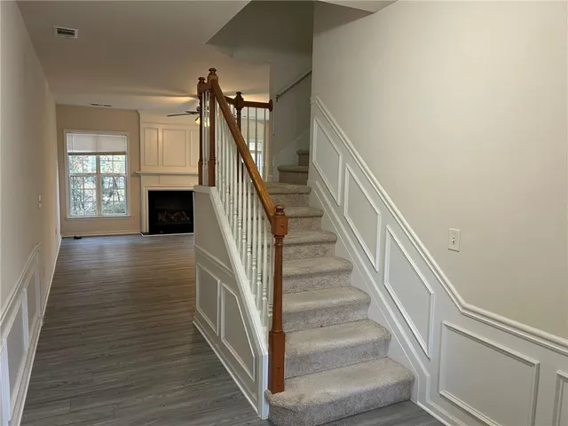 a view of entryway and hall with wooden floor