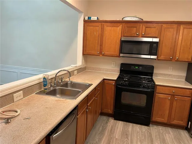 a kitchen with a sink stove and microwave