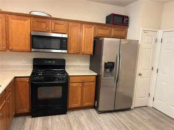 a kitchen with a refrigerator stove and microwave