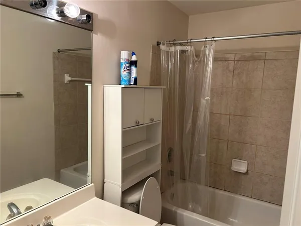 a bathroom with a shower and a sink