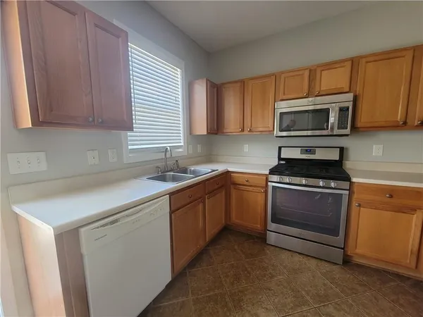 a kitchen with granite countertop a sink and steel appliances
