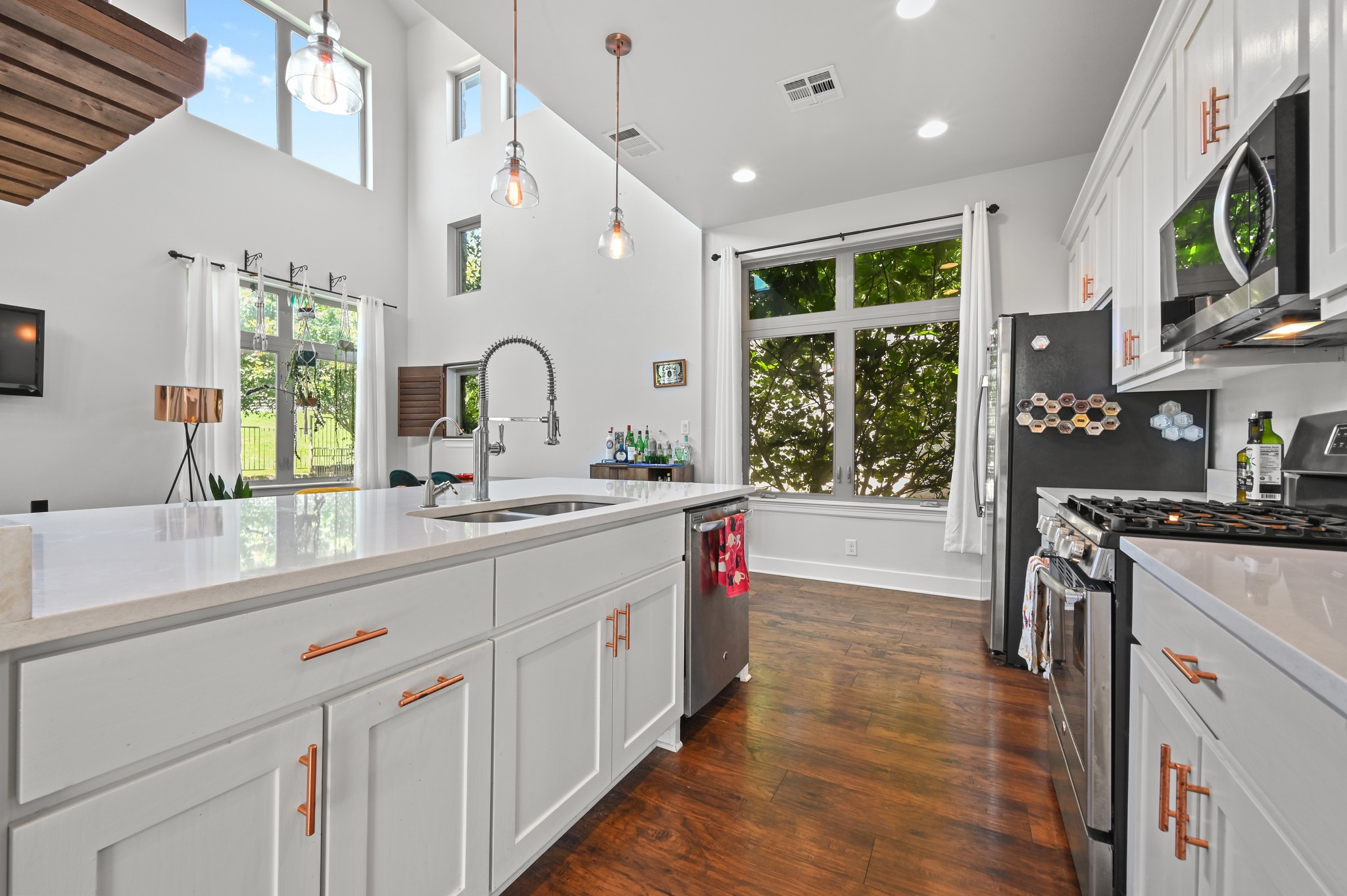 592 Farm To Market 967, Unit B Buda, TX 78610 - Photo 6 of 26 Designed with both style and function in mind, the kitchen showcases crisp white cabinetry, rich hardwood floors, and an open layout that keeps everyone connected.