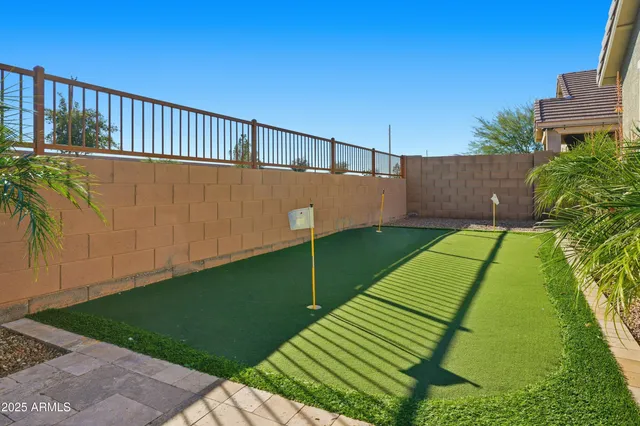 a view of a tennis ground with large trees