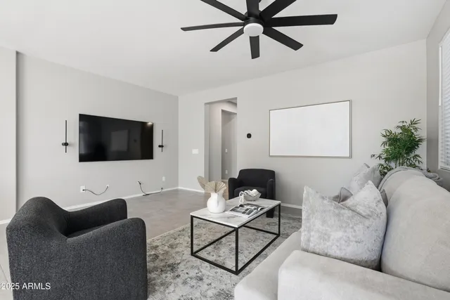 a living room with furniture and kitchen view