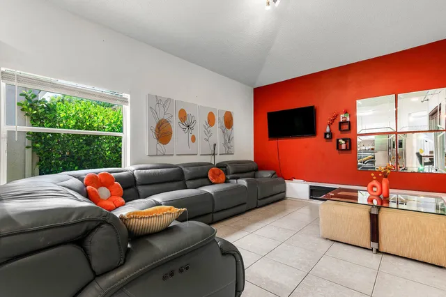 a living room with furniture a couch and a flat screen tv