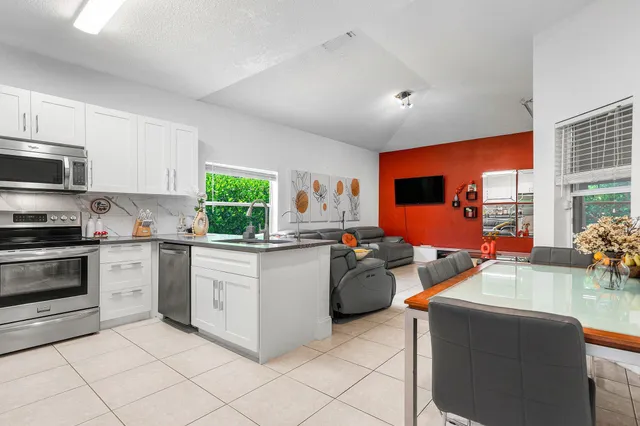 a kitchen with stainless steel appliances granite countertop a sink and a stove