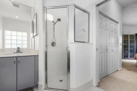 a bathroom with a shower sink and mirror