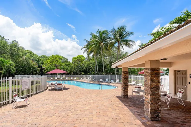 a view of a swimming pool with an outdoor seating