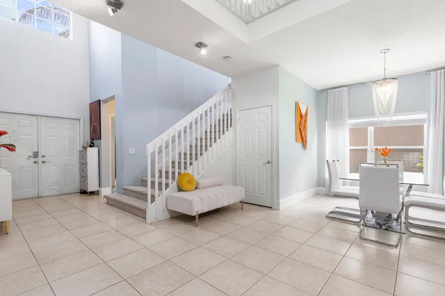 a view of an entryway with workspace and livingroom view