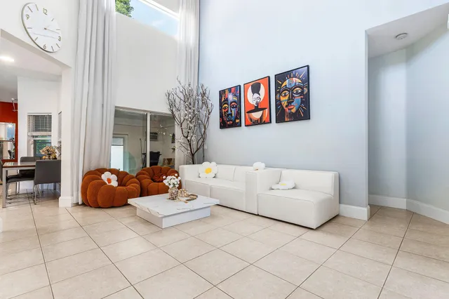 a living room with furniture and a painting on the wall