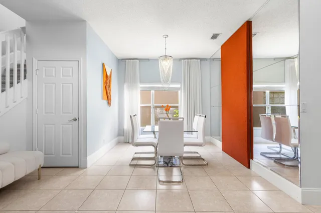 a living room with furniture a dining table and a large window