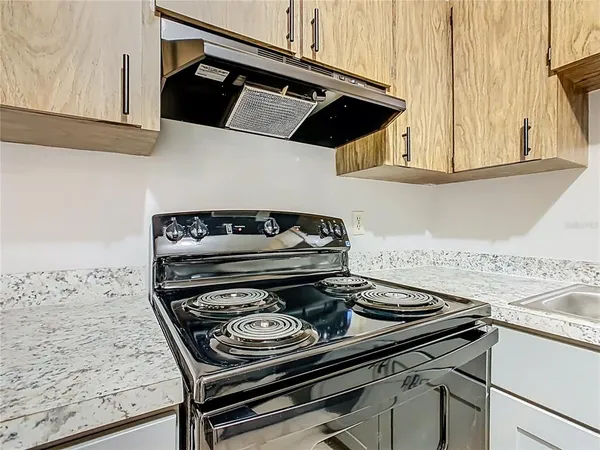 a stove top oven sitting inside of a kitchen