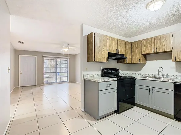 a kitchen with stainless steel appliances granite countertop a stove top oven a sink a counter top space and cabinets