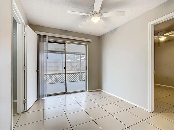 a view of a livingroom with a ceiling fan and window