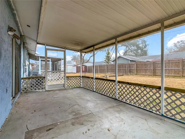 a view of a yard with wooden fence