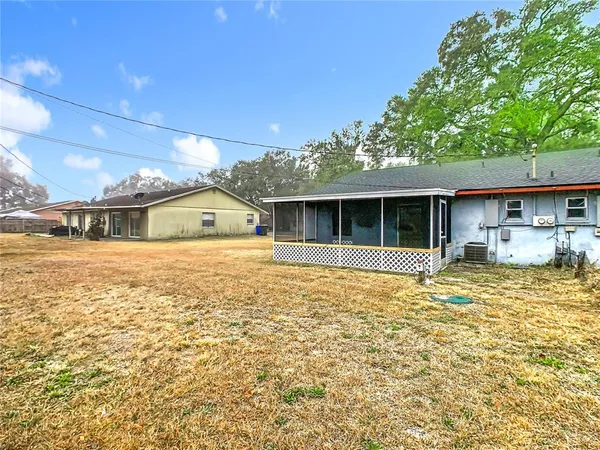 a view of a house with a large window and yard