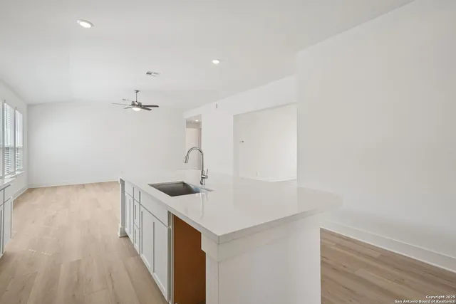 a kitchen with a sink and cabinets