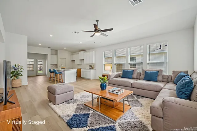a living room with furniture or kitchen view and a chandelier
