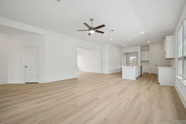a view of a kitchen with a sink and a refrigerator