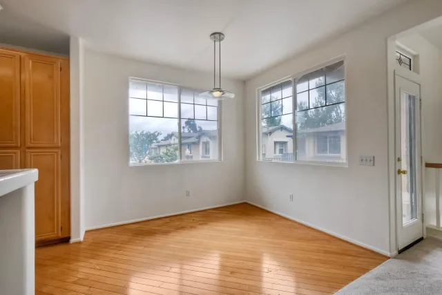 a view of a kitchen with a sink refrigerator and window
