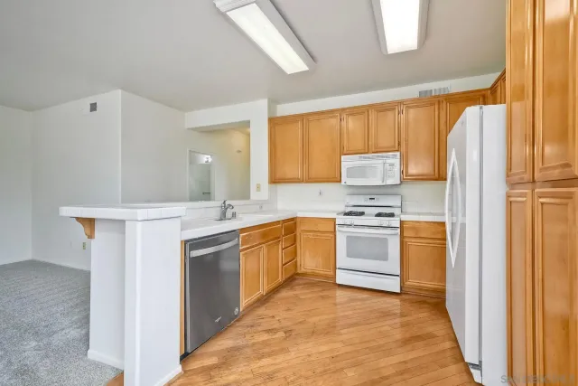a kitchen with stainless steel appliances a refrigerator sink and cabinets
