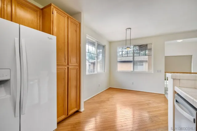 a kitchen with a sink cabinets and wooden floor