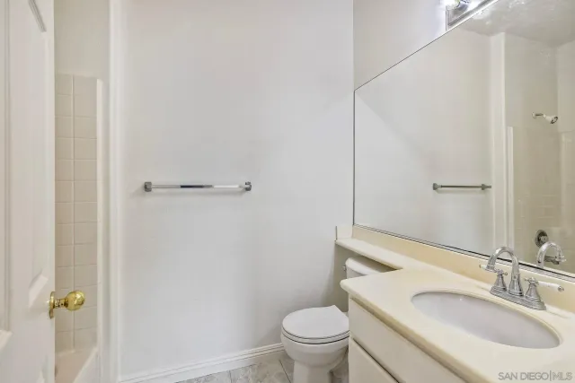 an empty room with windows and ceiling fan view