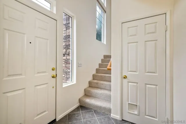 a view of a hallway with wooden floor and entryway