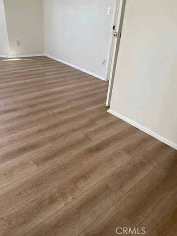 a view of room with wooden floor