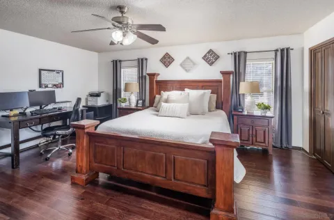 a bedroom with a bed and a chandelier