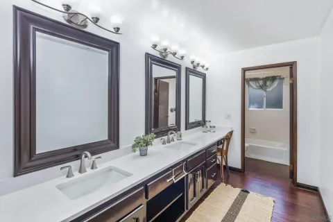 a bathroom with a sink double vanity and a mirror