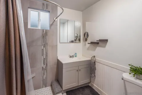 a bathroom with a sink a mirror and shower